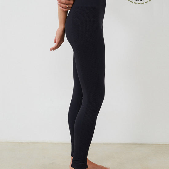 Vista lateral malla yoga larga mujer marca NOY (not only yoga) modelo GAIA sin costuras tono negro black lava