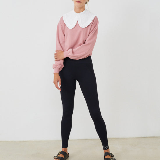Sudadera mujer con CUELLO independiente  NOY (not only yoga) modelo CÉCILE de algodón orgánico blanco atado con botón en la parte delantera y combinado con legging negro y sandalias  negras